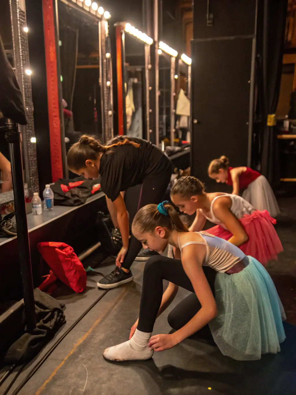 A photo of young dancers in costume backstage, preparing for a children's dance competition organized by ARABESQUE.
